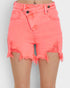Coral pink denim shorts with a high-waisted fit, frayed raw hems, and distressed details, shown on a model against a light gray background.