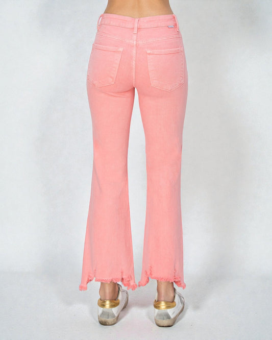 Pink jeans worn by a person on a white background