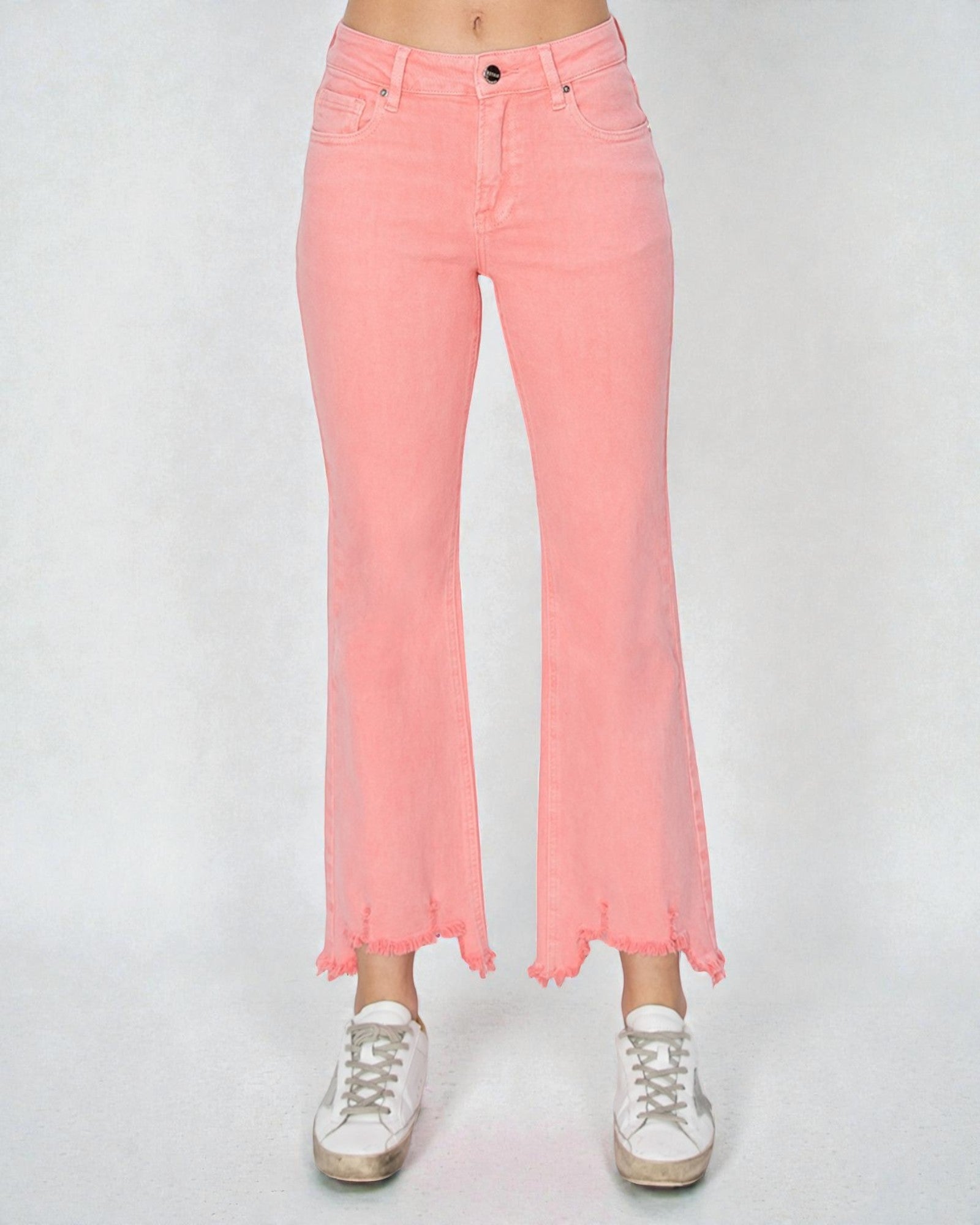 Pink jeans worn by a person on a white background