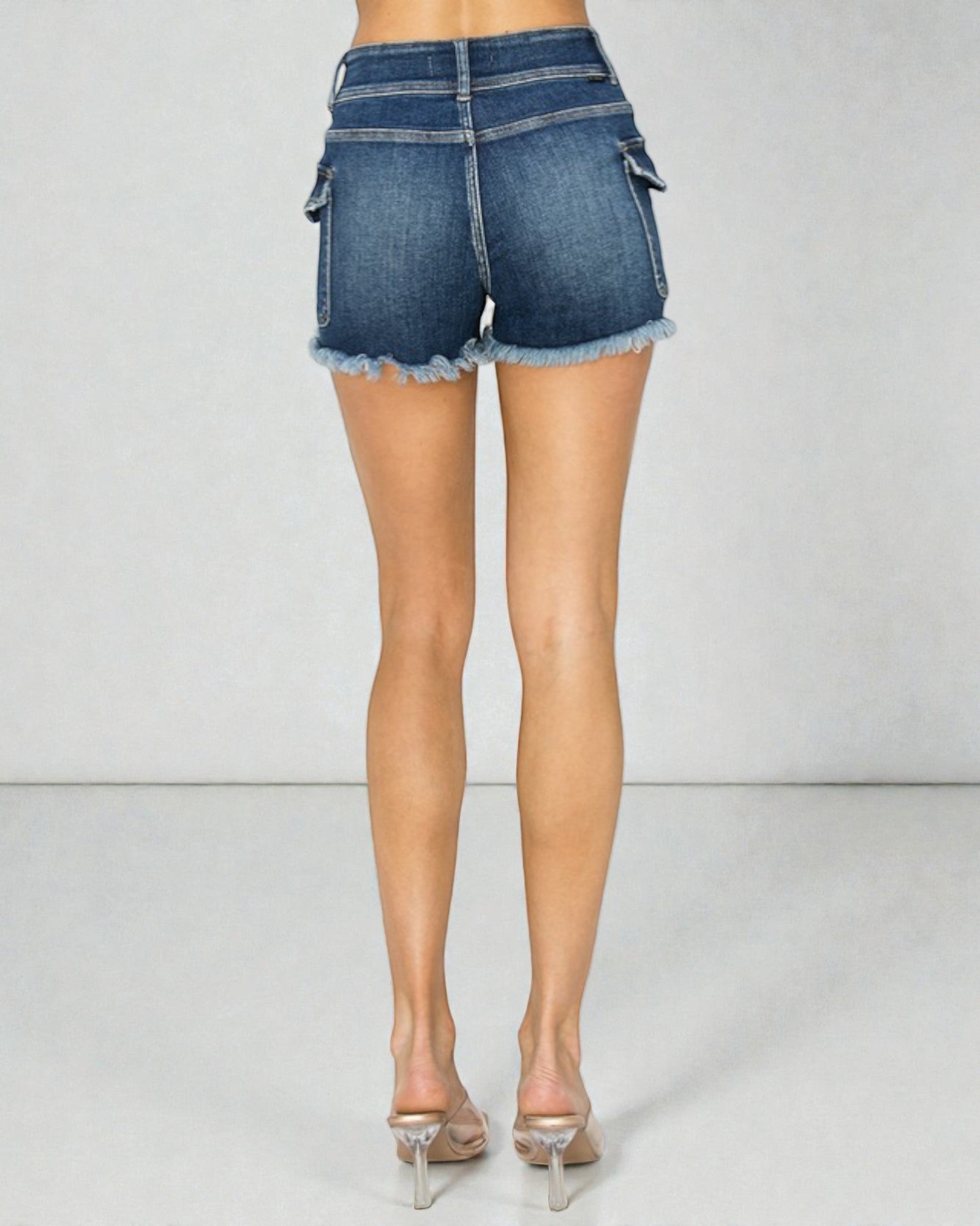 Person wearing blue denim shorts on a plain background