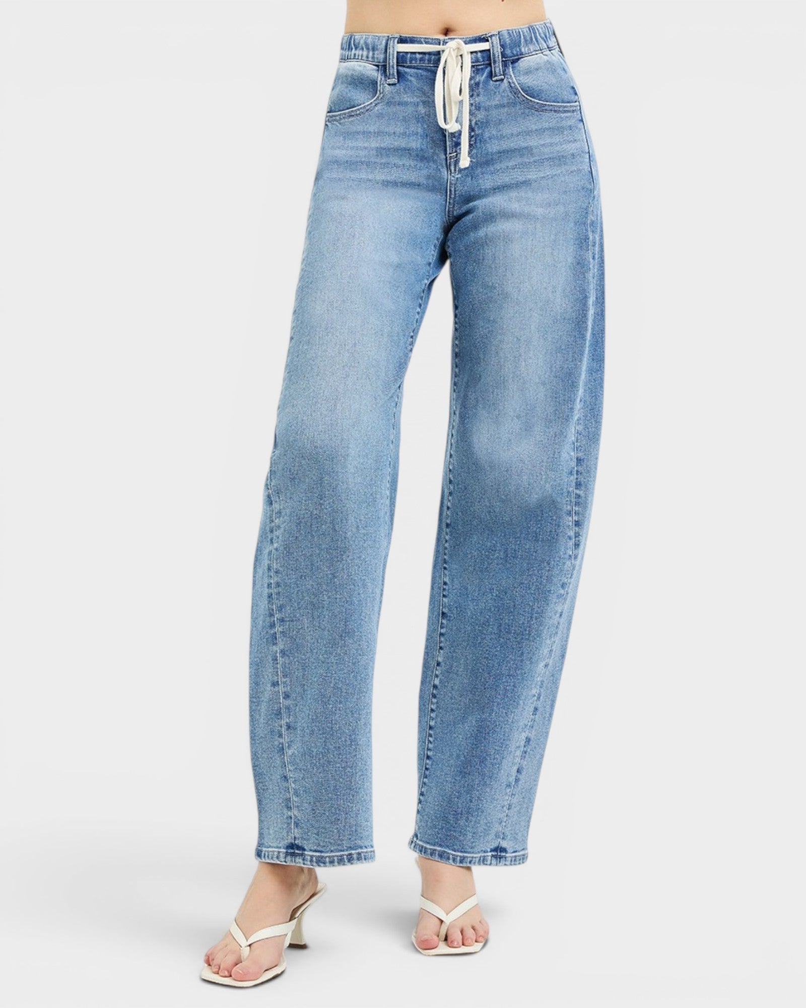 Light blue jeans worn by a person on a white background