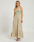 Woman wearing a green top and beige wide-leg pants on a white background