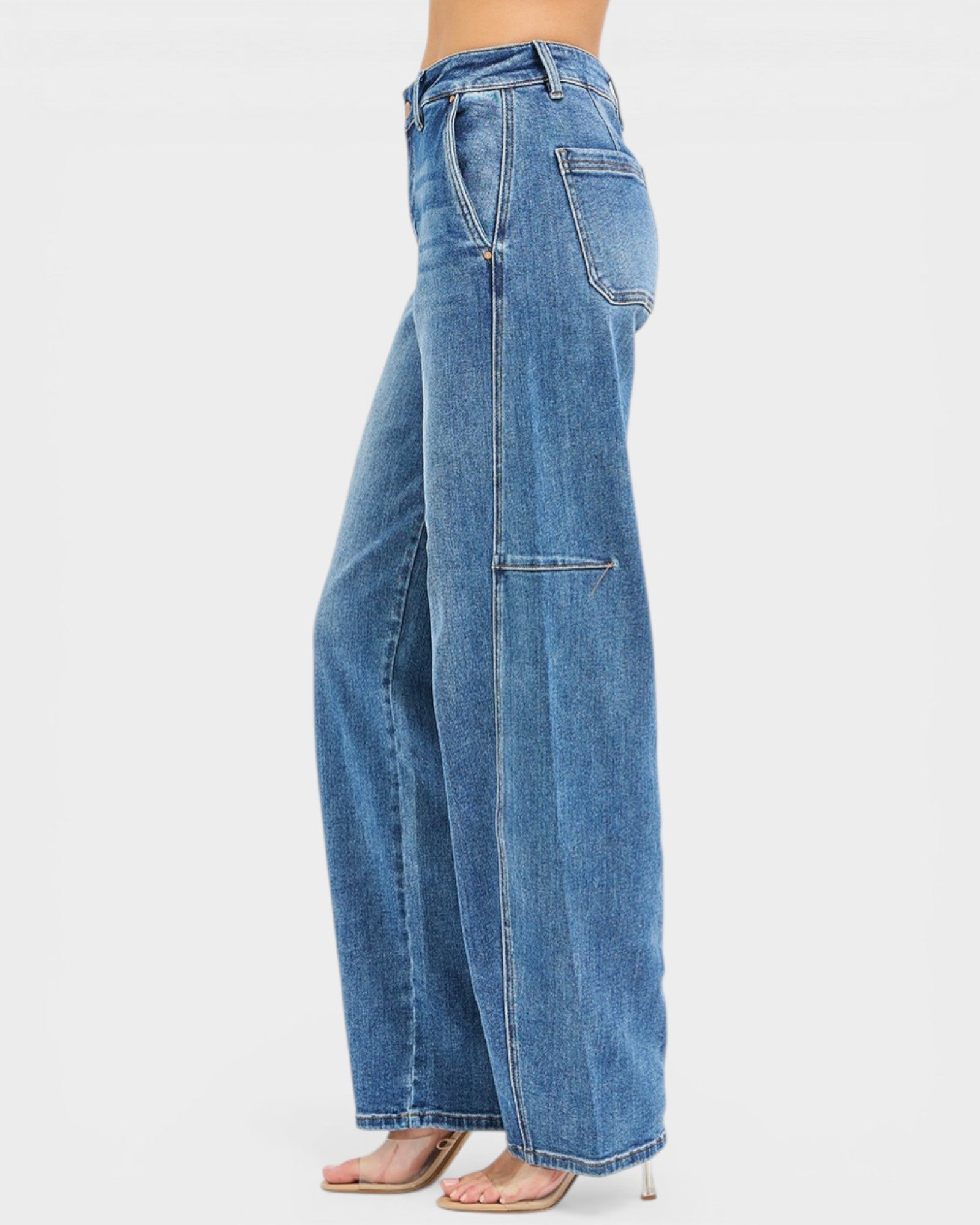 Blue jeans worn by a person on a white background