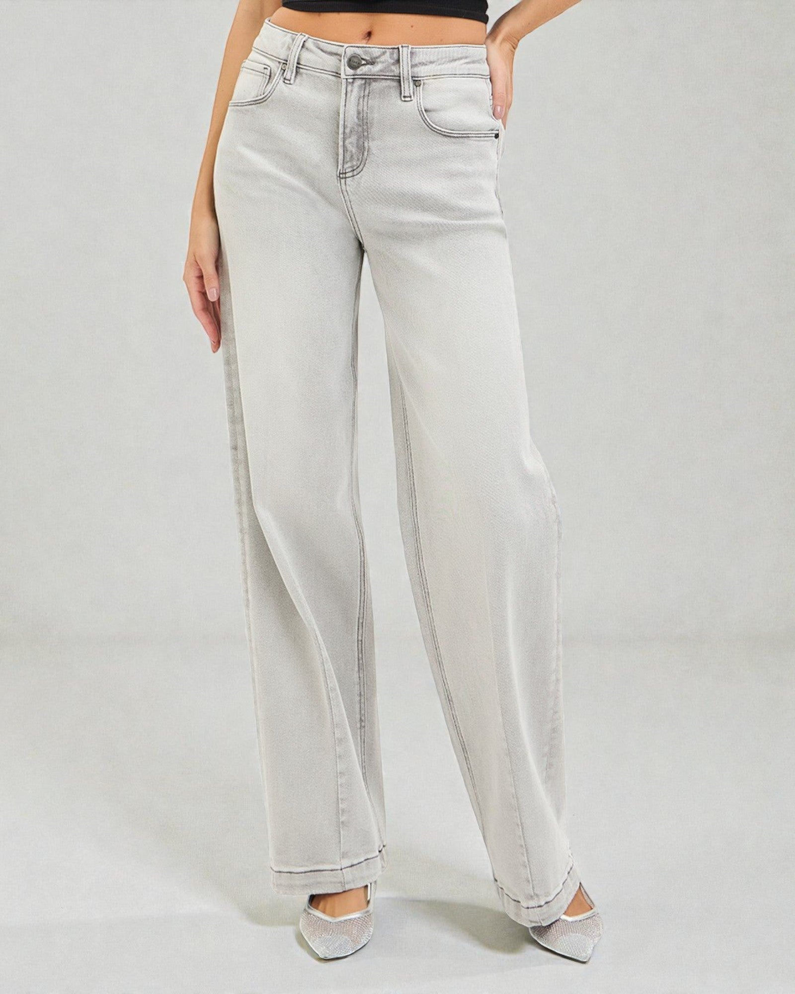 Light blue jeans worn by a person on a plain background