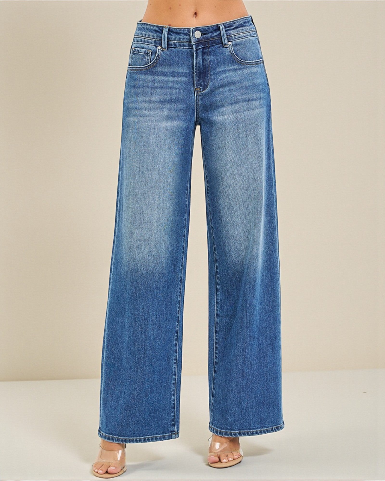 Blue wide-leg jeans on a neutral background