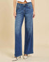 Blue jeans worn by a person on a beige background