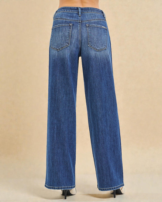 Blue jeans worn by a person on a beige background