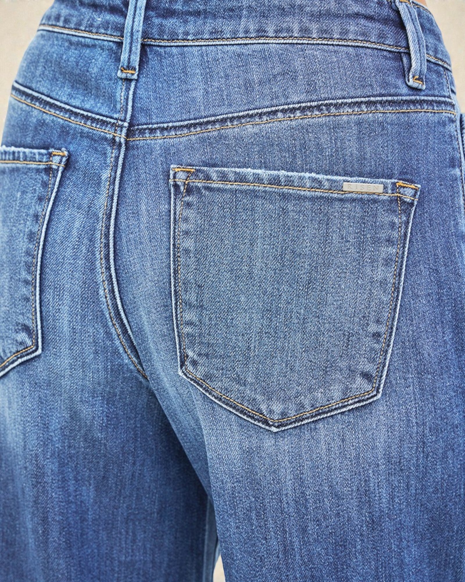 Close-up of blue jeans with a focus on the back pocket.