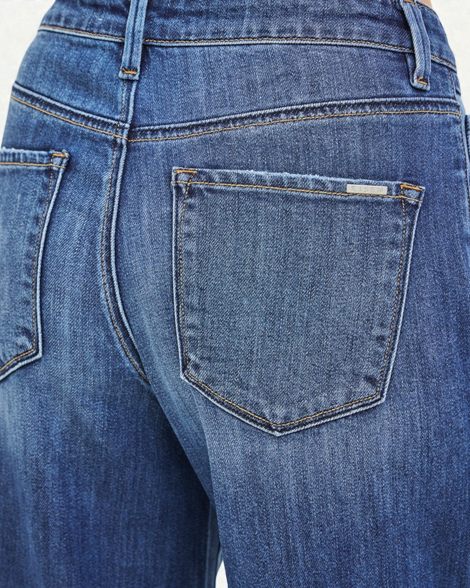 Close-up of blue jeans with a focus on the back pocket.