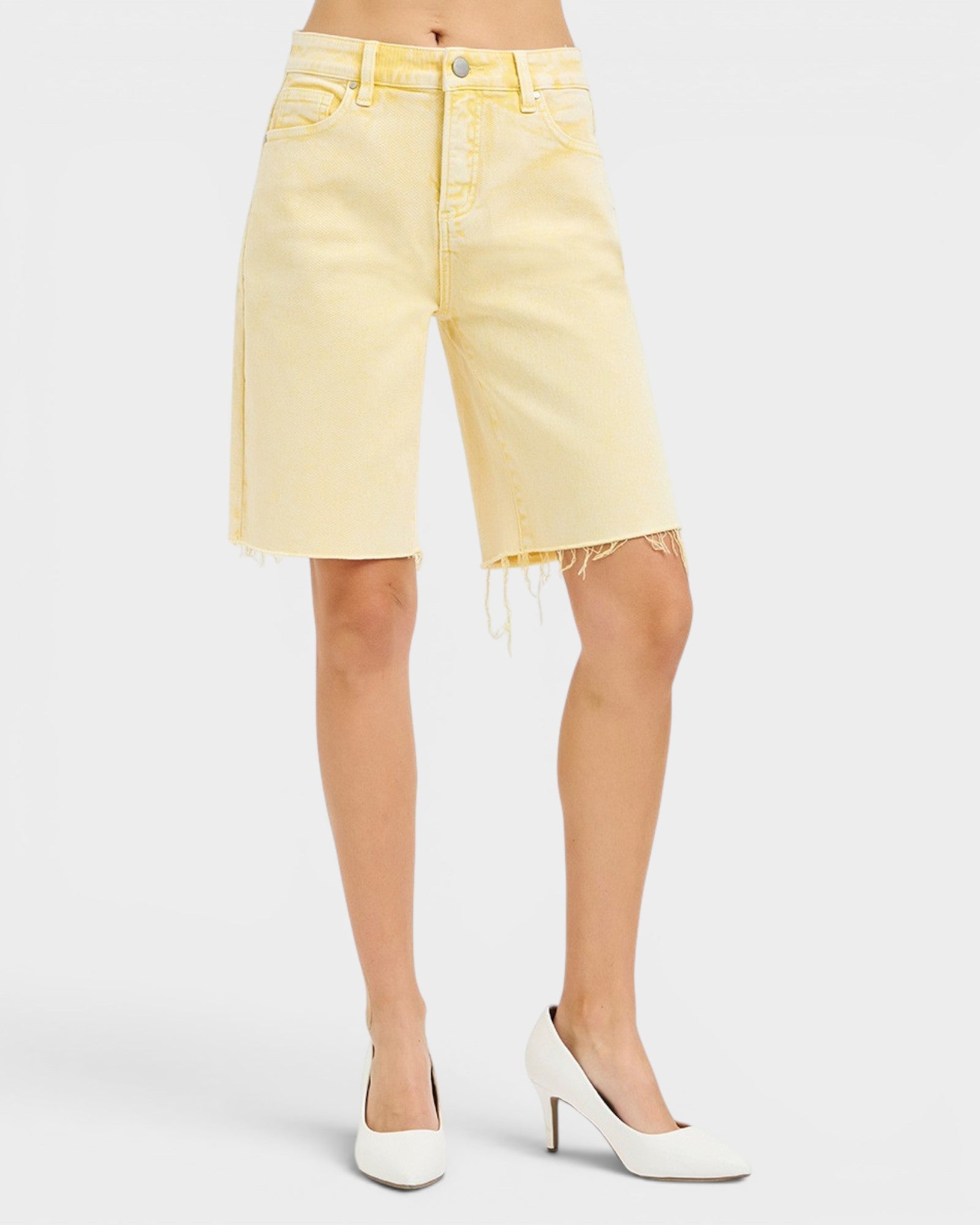 Yellow denim shorts worn by a person on a white background