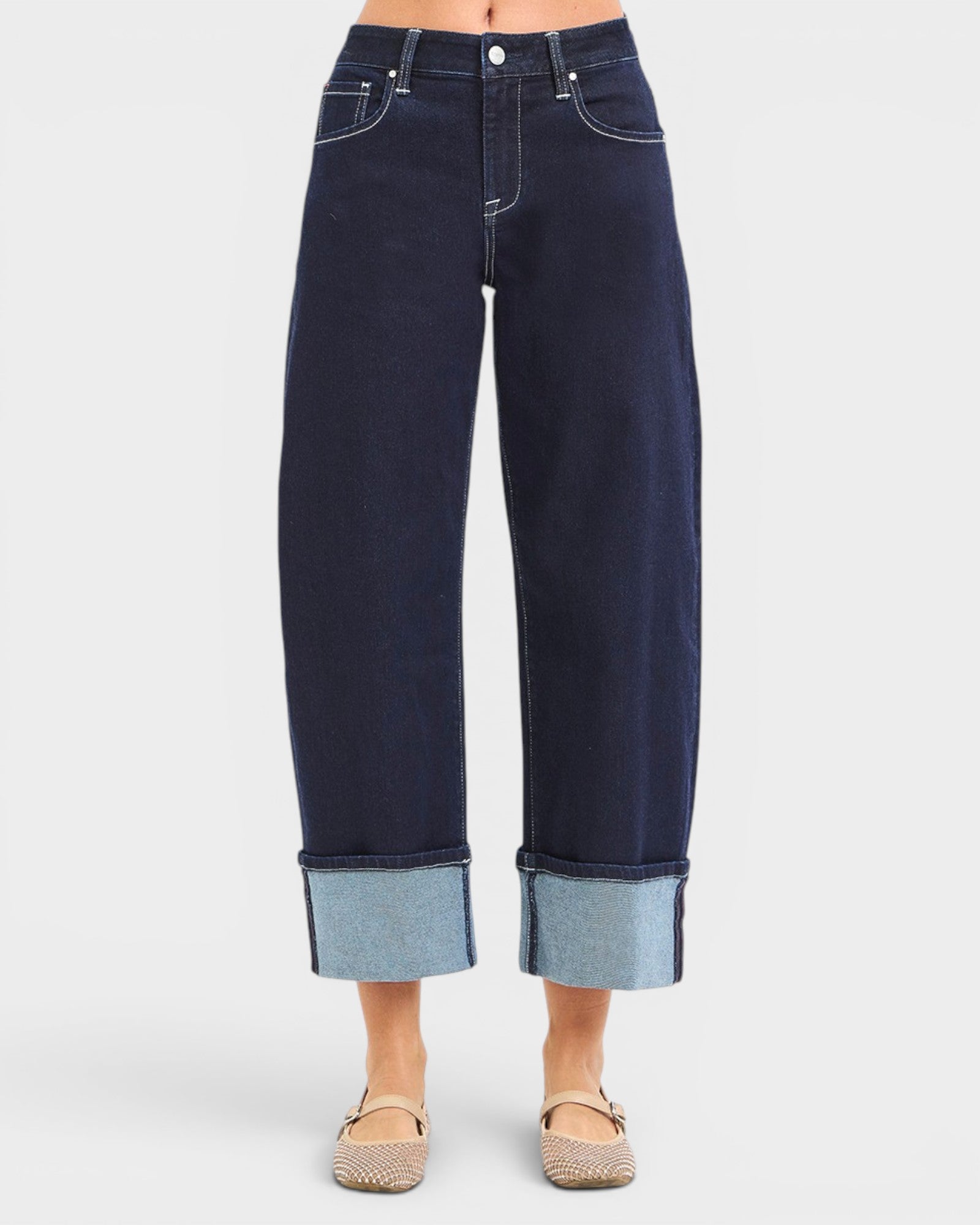 Dark blue jeans with cuffed hems on a white background