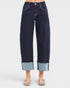 Dark blue jeans with cuffed hems on a white background