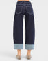 Navy blue jeans with cuffed hem on a white background