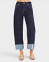 Dark blue jeans with light blue cuffs worn by a person on a white background