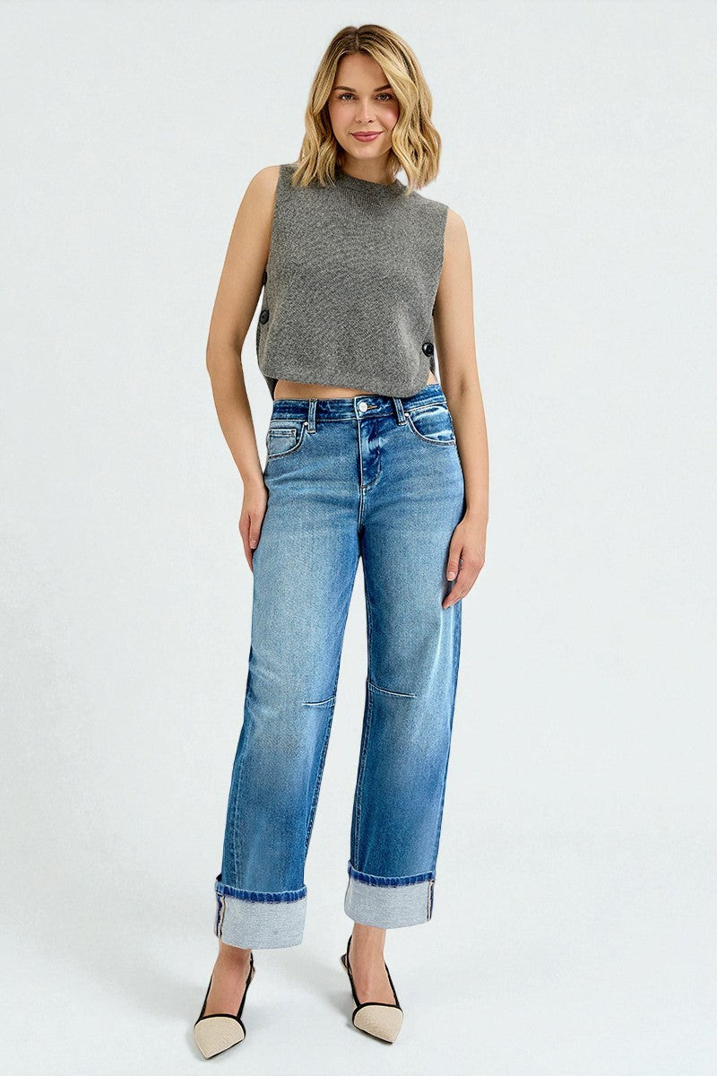 Woman wearing a gray sleeveless top and blue jeans on a white background