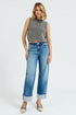 Woman wearing a gray sleeveless top and blue jeans on a white background