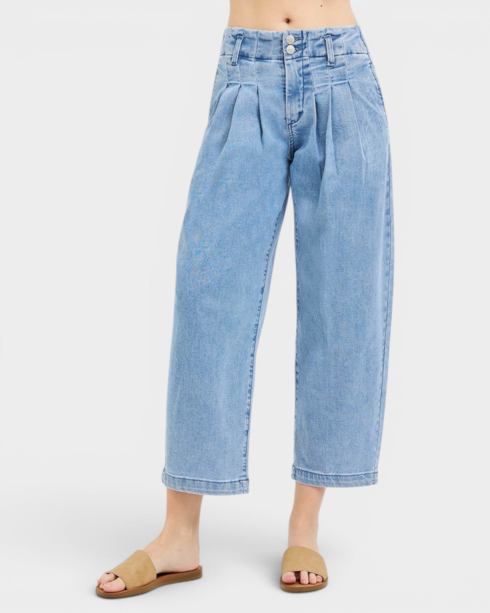 Light blue jeans worn by a person on a white background
