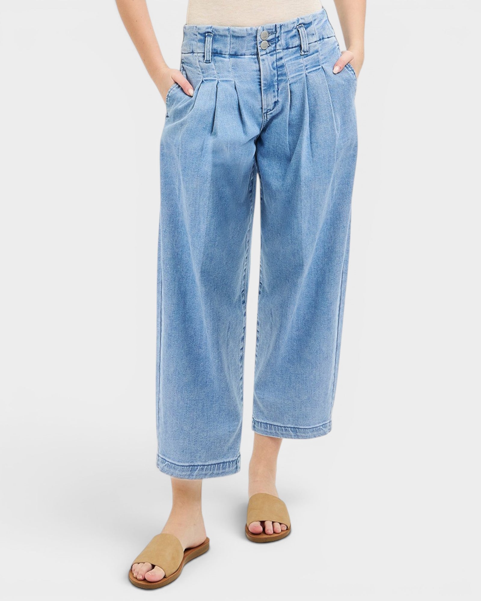 Light blue denim pants worn by a person on a white background