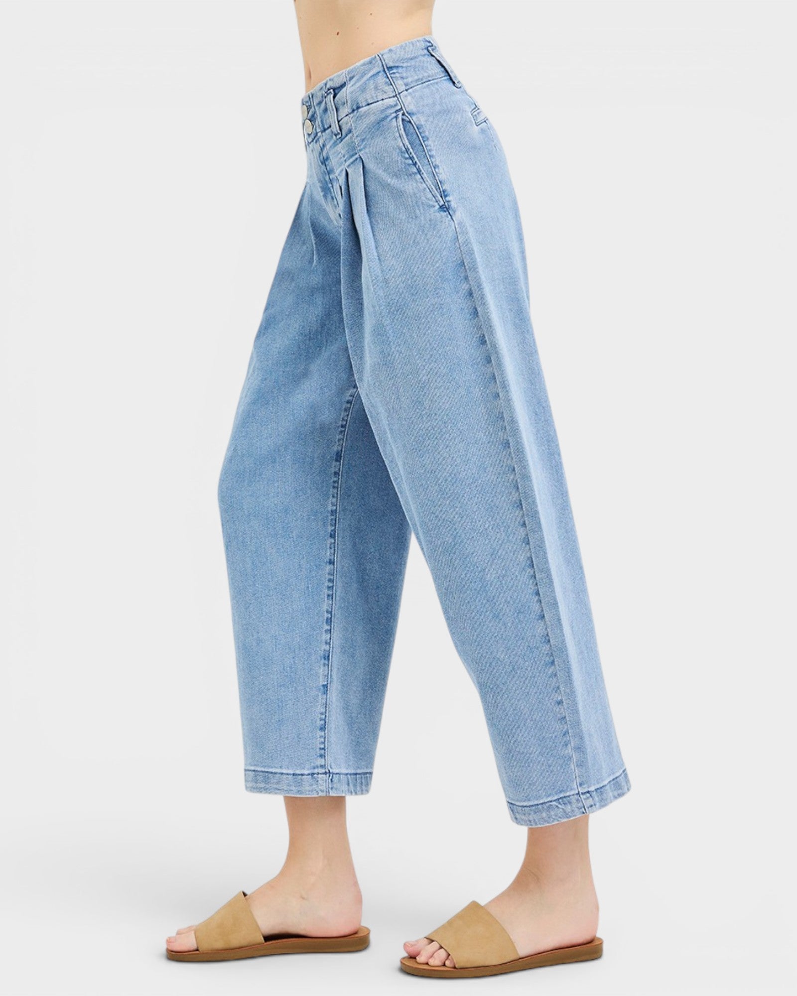 Light blue denim jeans worn by a person on a white background