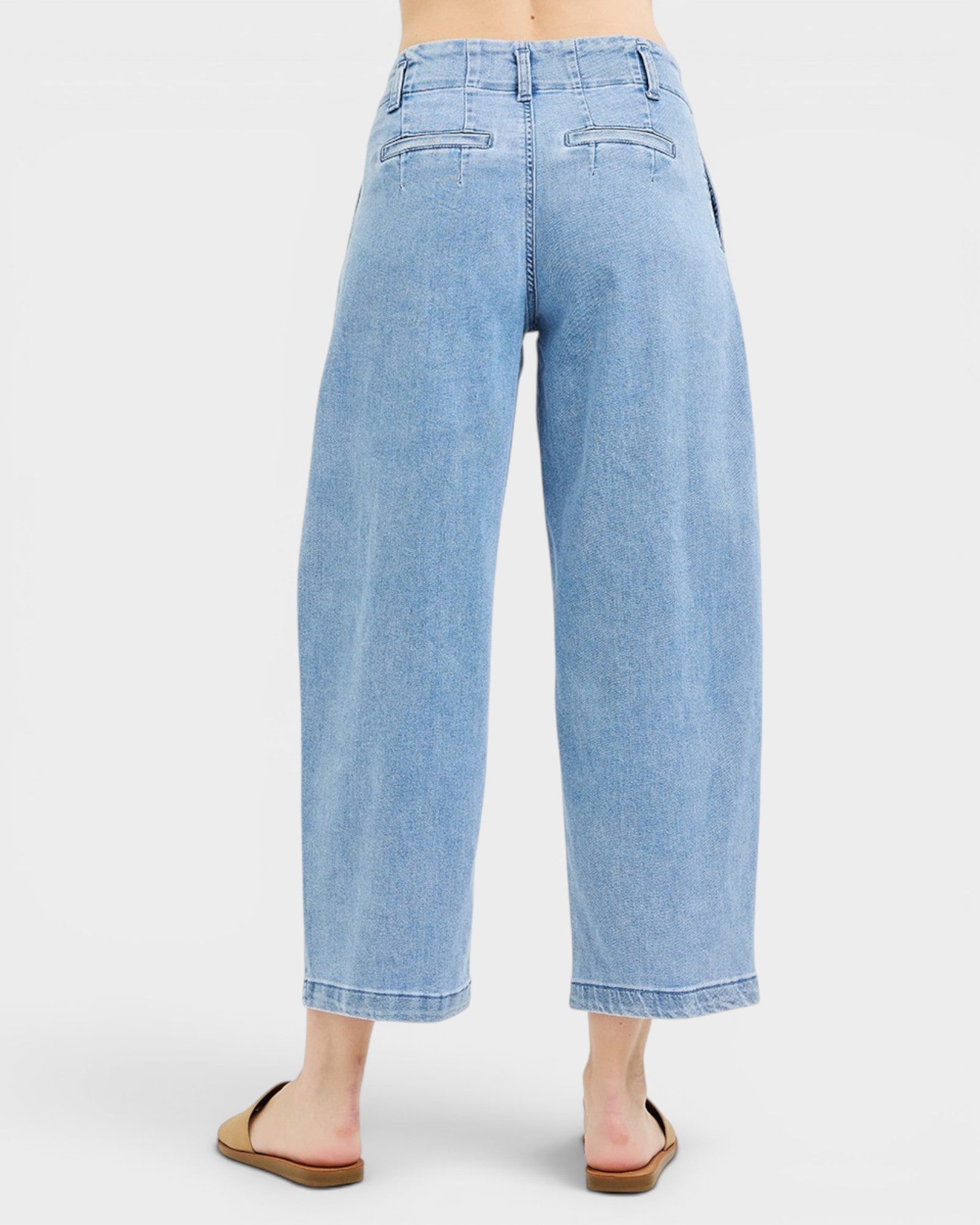 Light blue denim jeans on a white background