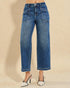 Blue jeans worn by a person on a beige background