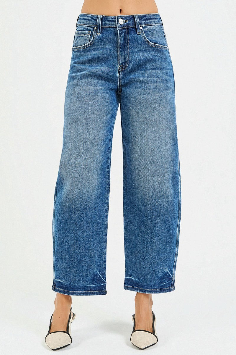 Blue jeans worn by a person on a white background