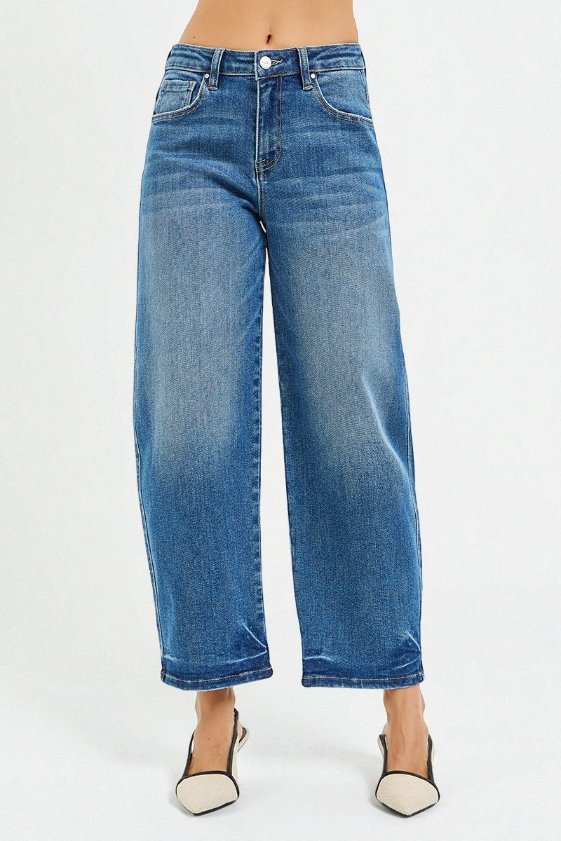 Blue jeans worn by a person on a white background