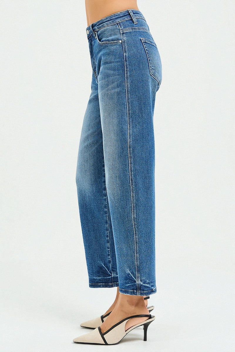 Blue jeans worn by a person on a white background
