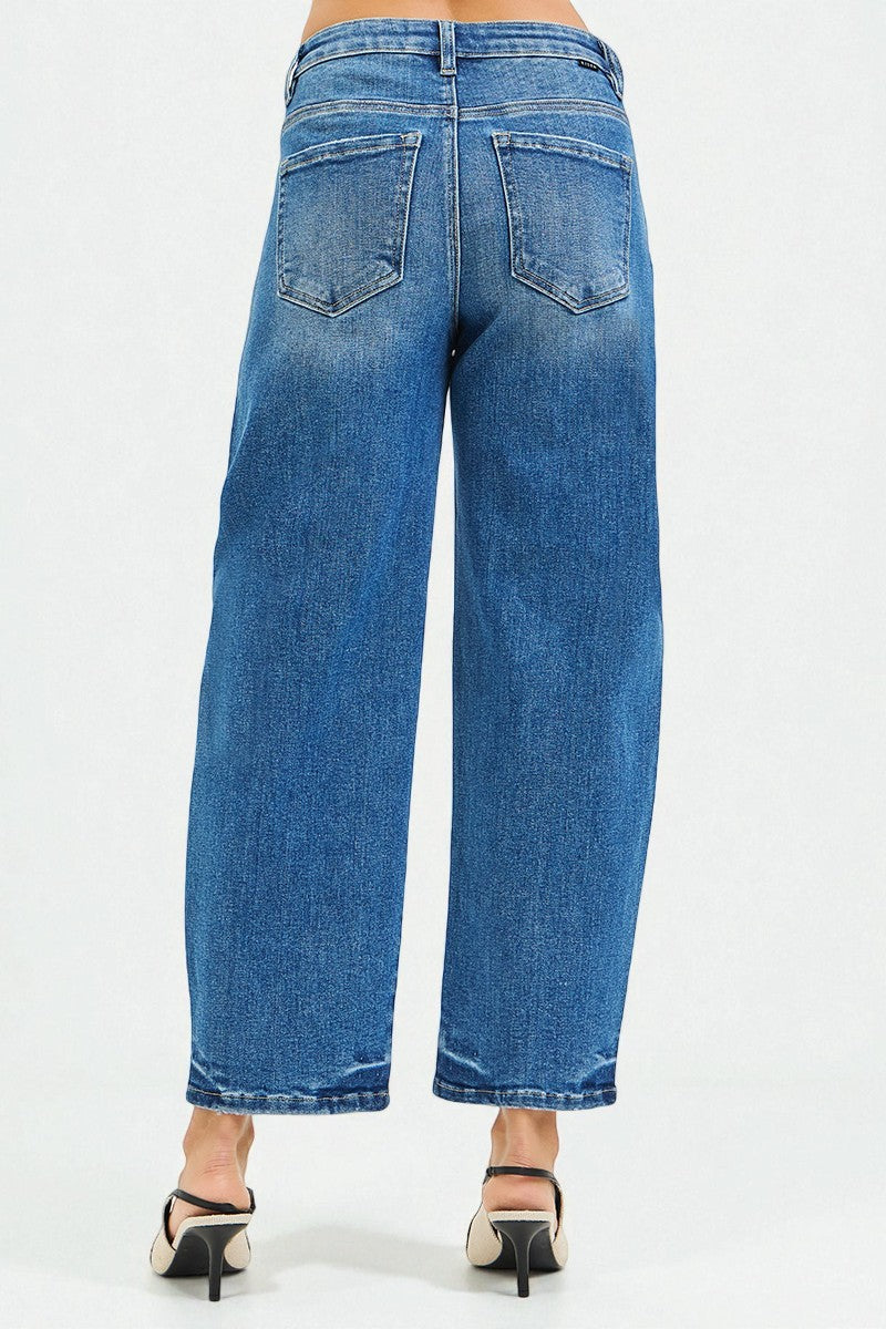 Blue jeans worn by a person on a white background