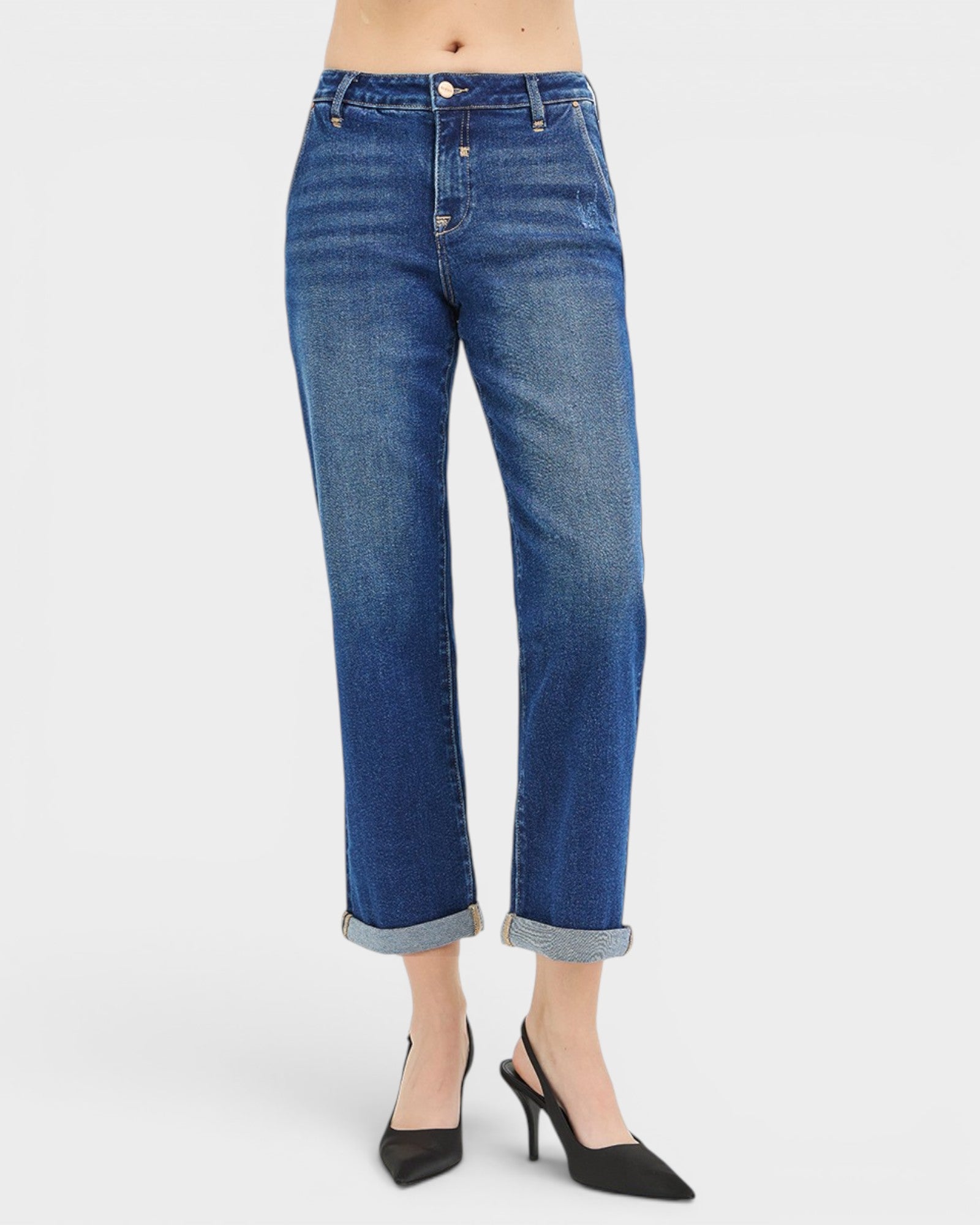 Blue jeans worn by a person on a white background