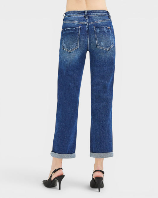 Blue jeans worn by a person on a white background