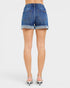 Blue denim shorts worn by a person on a white background