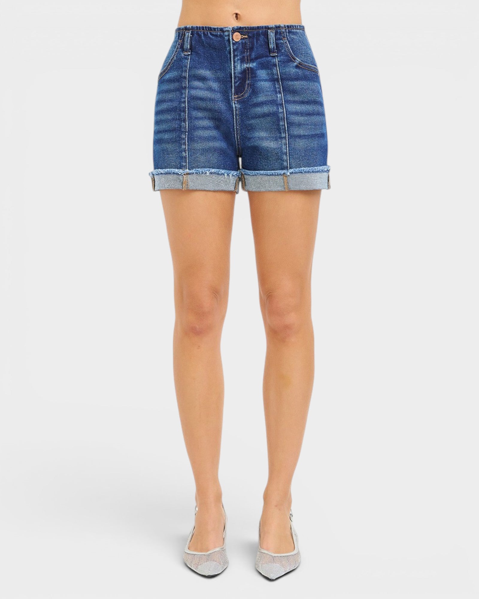 Denim shorts worn by a person on a white background