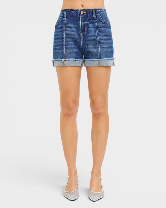Denim shorts worn by a person on a white background