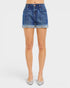 Denim shorts worn by a person on a white background
