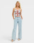 Woman wearing a Union Jack top and light blue jeans on a white background