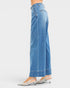 Blue jeans worn by a person on a white background