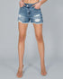 Denim shorts with slight distressing on a gray background