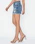 Denim skirt worn by a person on a white background