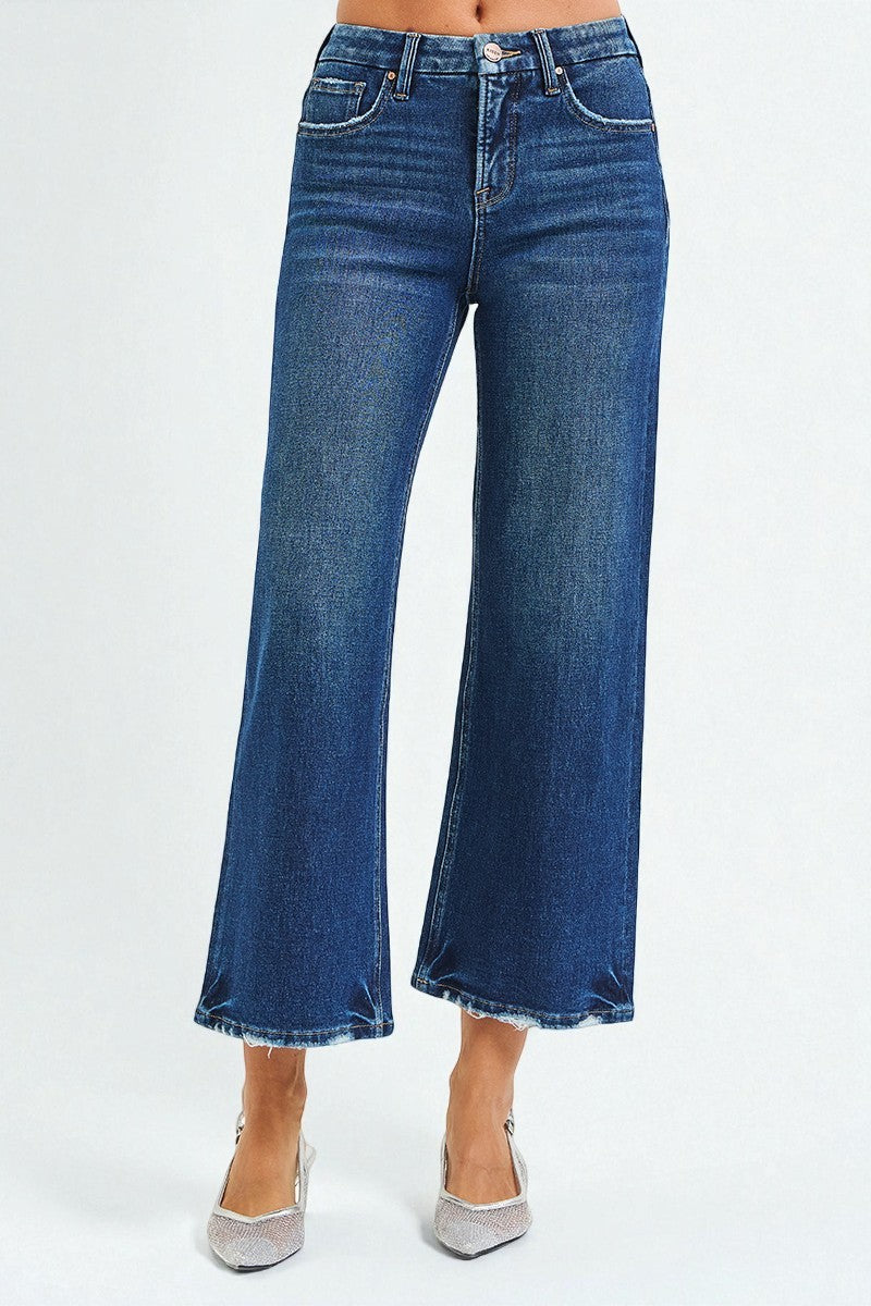 Blue jeans worn by a person on a white background