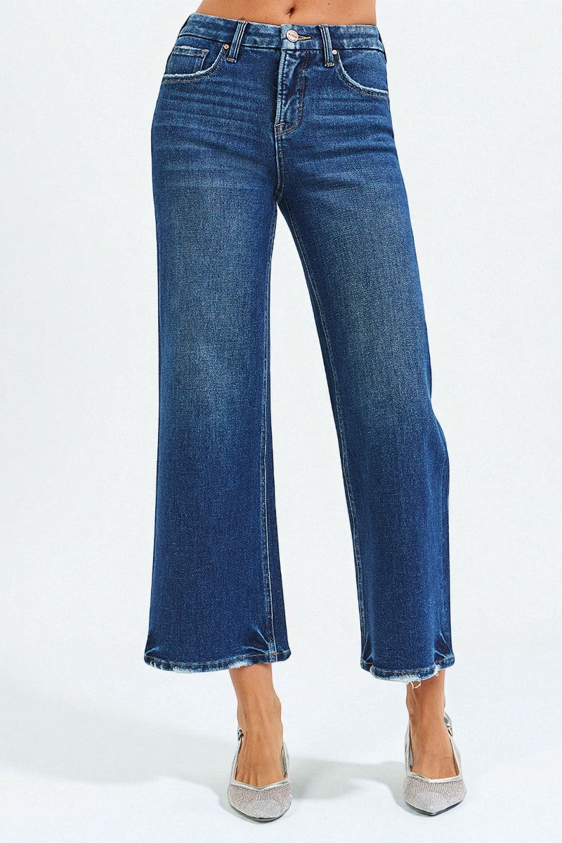 Blue jeans worn by a person on a white background