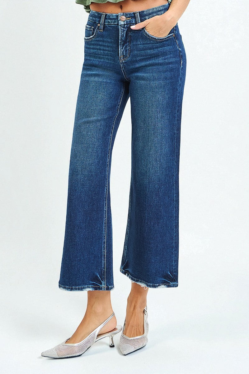 Blue jeans worn by a person on a white background