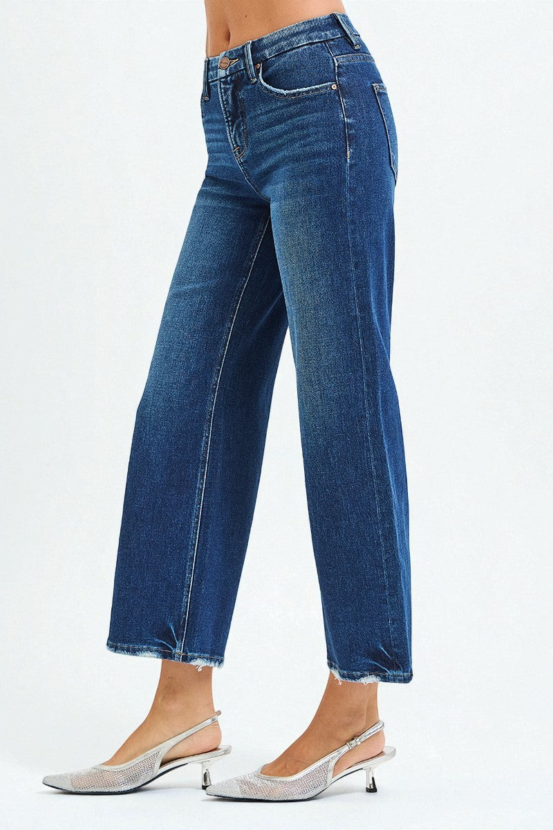 Blue jeans worn by a person on a white background