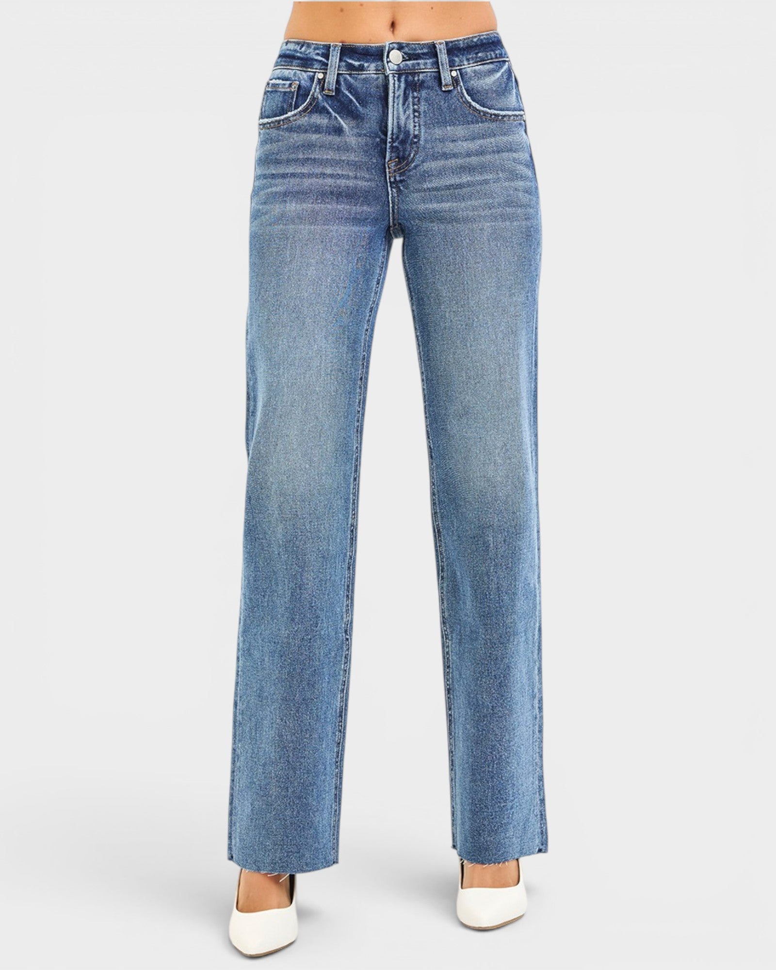 Blue jeans worn by a person on a white background