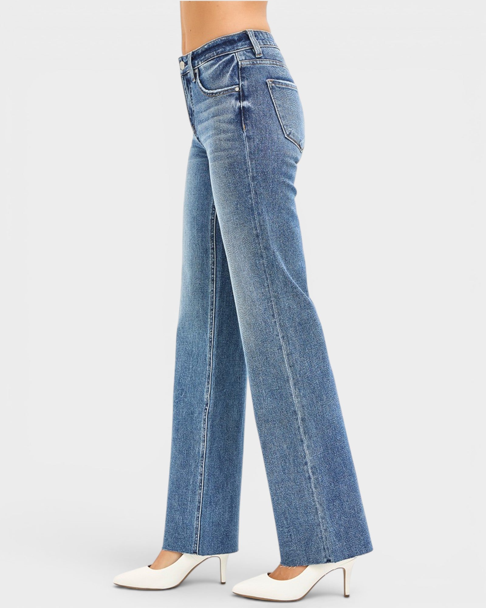 Blue jeans worn by a person on a white background
