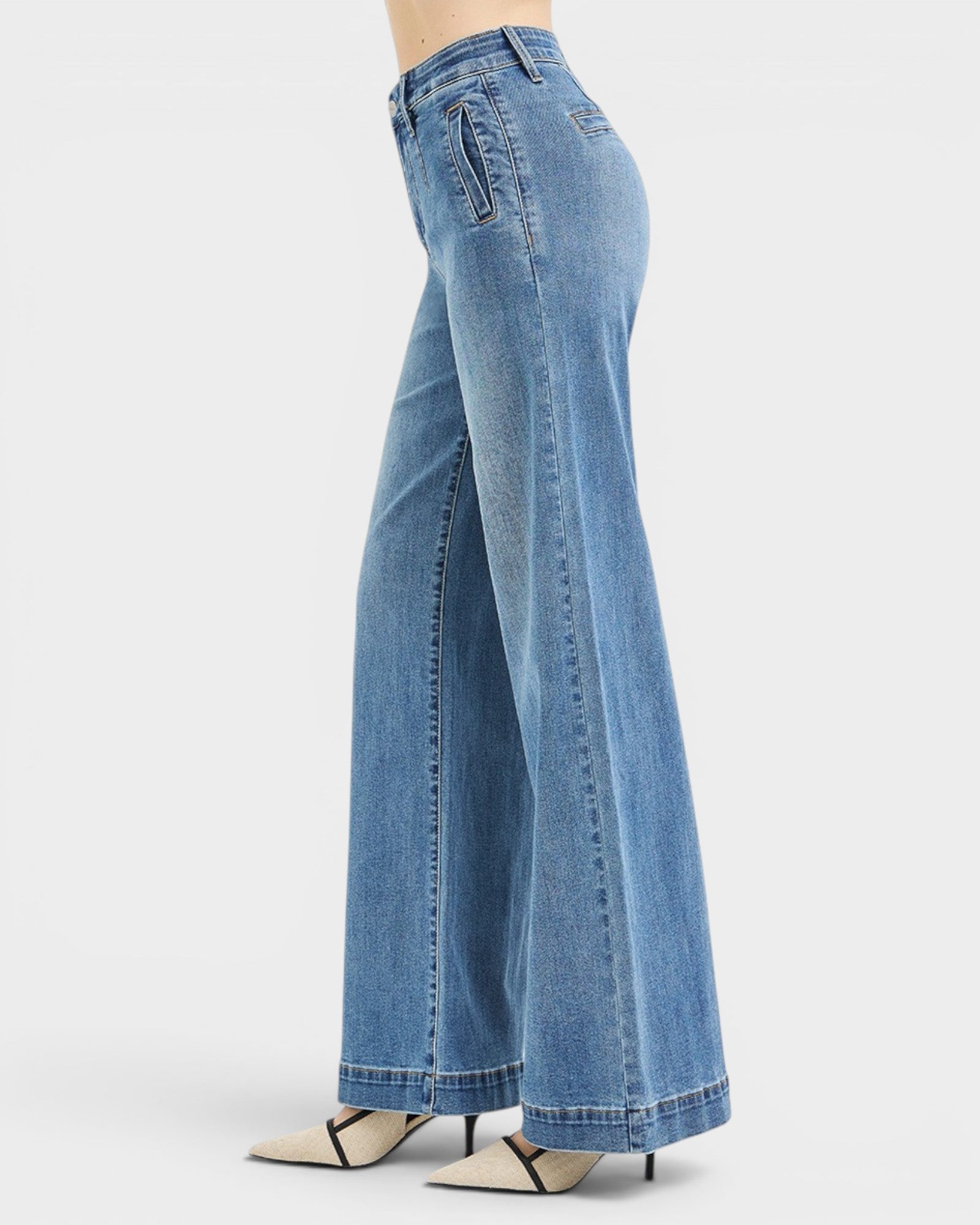 Blue jeans worn by a person on a white background