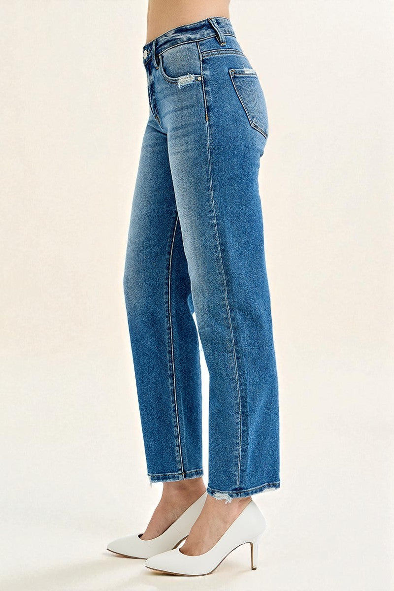 Blue jeans worn by a person on a beige background