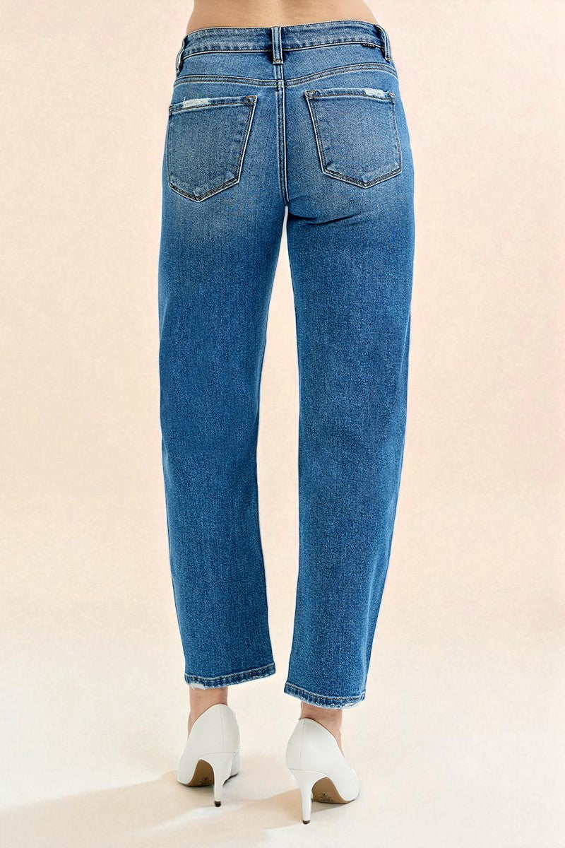 Blue jeans worn by a person on a beige background