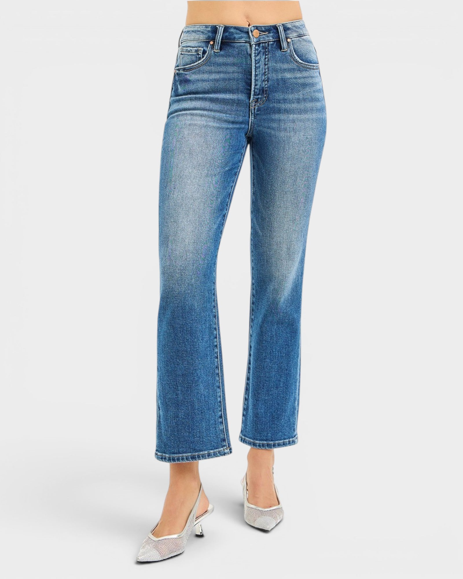 Blue jeans worn by a person on a white background