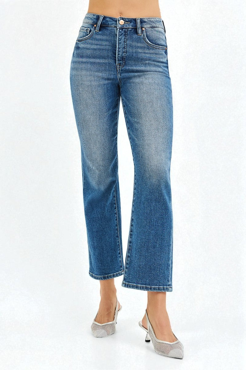 Blue jeans worn by a person on a white background